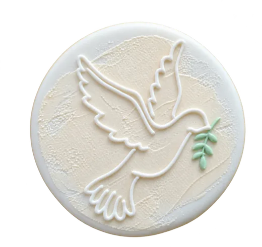 Cream baptism cookie with a piped dove