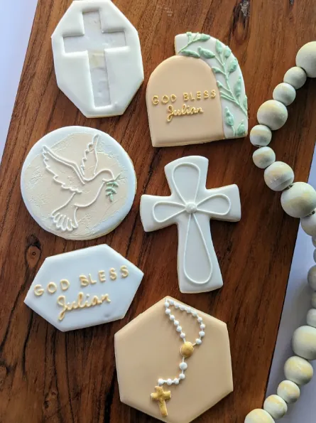 Cream and gold baptism cookies with a dove, cross and rosary