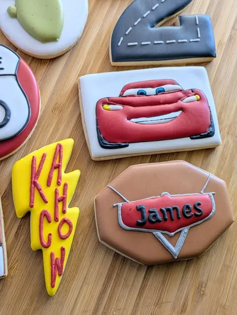 Cars themed birthday cookies with Lightning McQueen and Kachow lettering