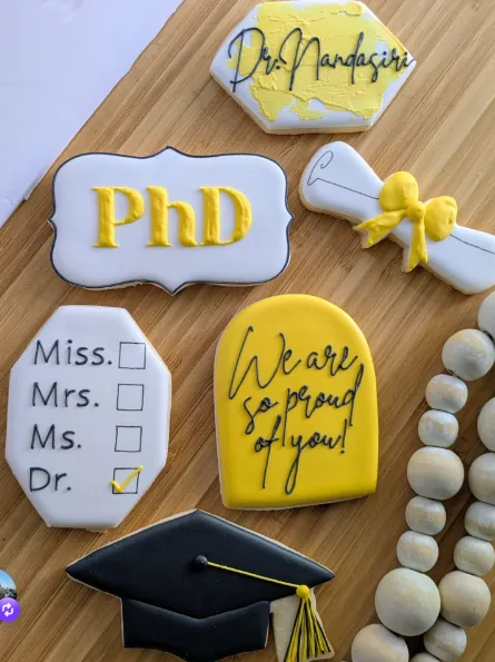 PhD graduation cookies with a Dr checklist, diploma and cap