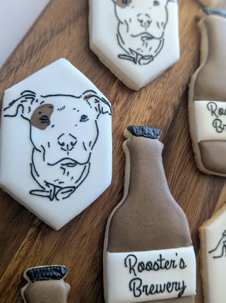 Hand-illustrated dog portrait cookies with brewery bottle cookies